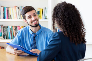 Male job candidate smiling at woman during a job interview