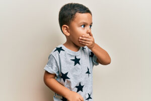 Young boy feeling unwell and coughing