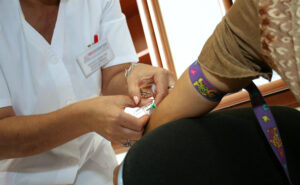 Medical provider taking blood sample from patient