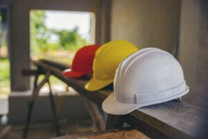 Picture of three hard hats at a construction site.