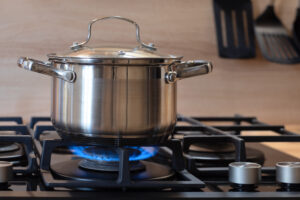 Picture of a stainless-steel pot on a hot stove.